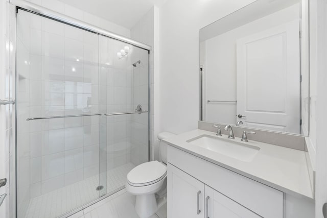 bathroom with vanity, toilet, and a shower with door