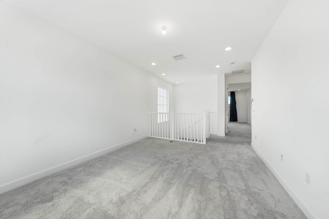 unfurnished room with light colored carpet