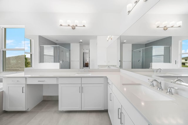 bathroom with tile patterned flooring, vanity, and walk in shower