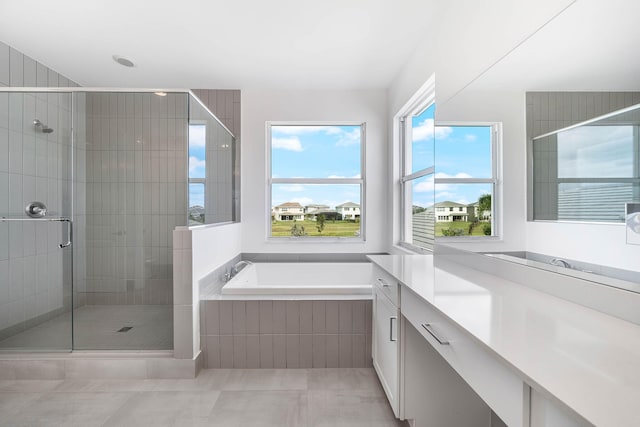 bathroom featuring tile patterned floors, vanity, and independent shower and bath