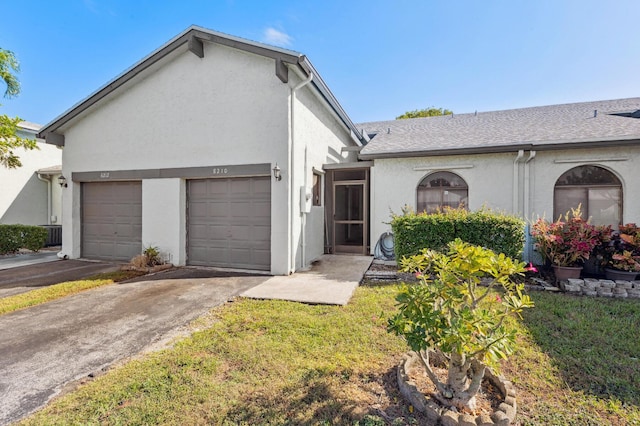 ranch-style house with a front lawn and a garage