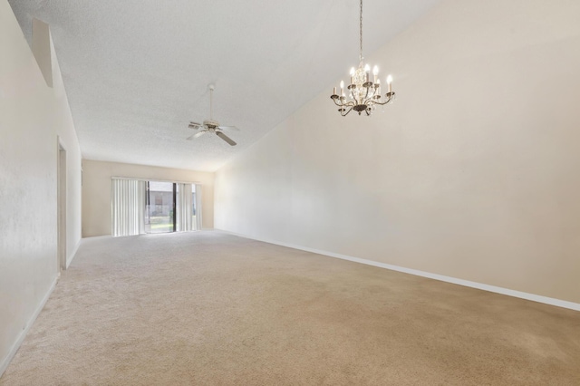 carpeted empty room featuring a textured ceiling, ceiling fan with notable chandelier, and vaulted ceiling