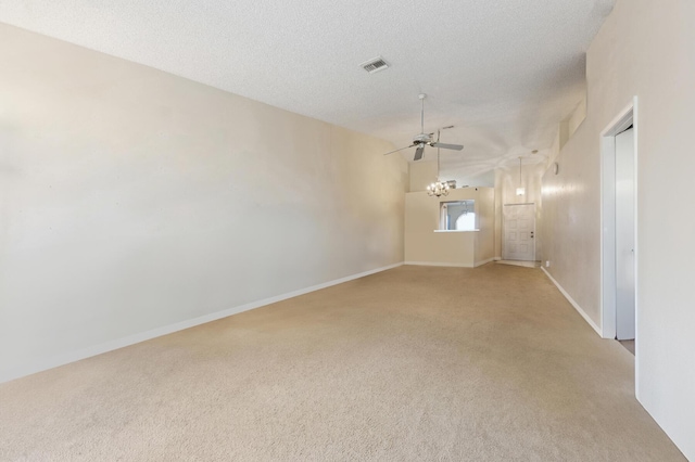 unfurnished room with ceiling fan, light colored carpet, and a textured ceiling