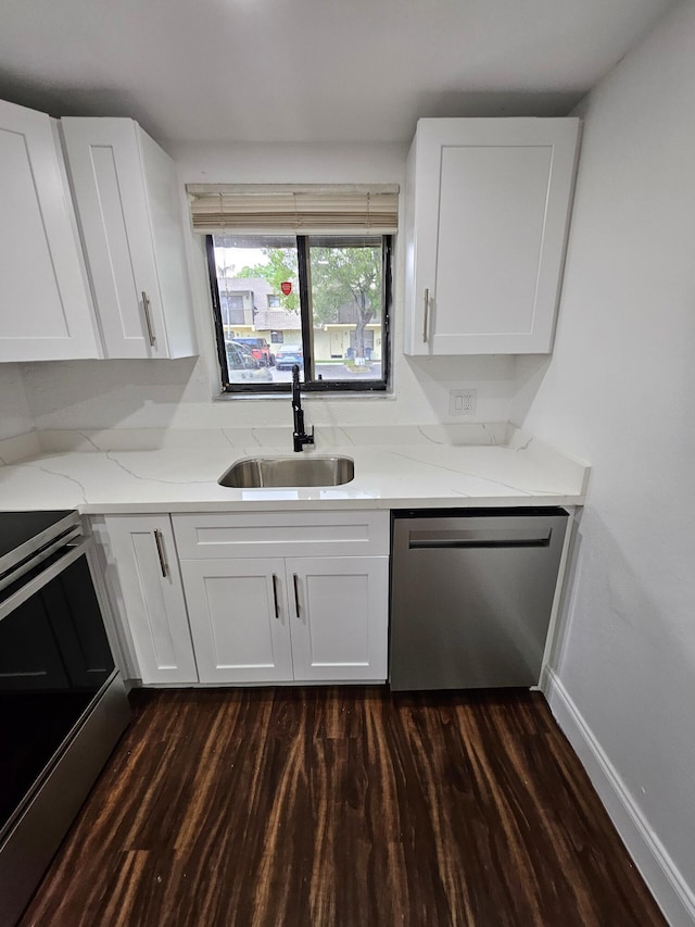 kitchen featuring stove, stainless steel dishwasher, dark wood-type flooring, sink, and white cabinets