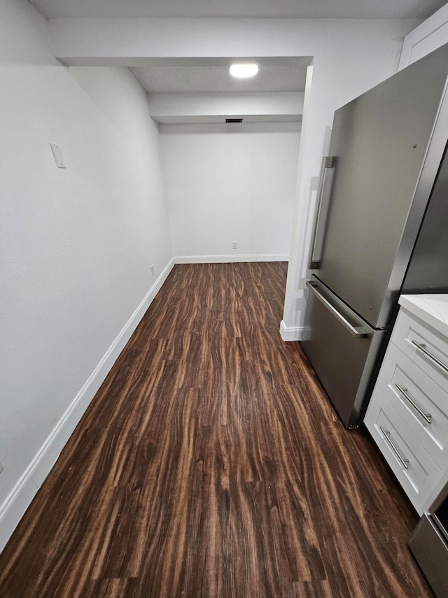 interior space with stainless steel fridge and dark hardwood / wood-style floors