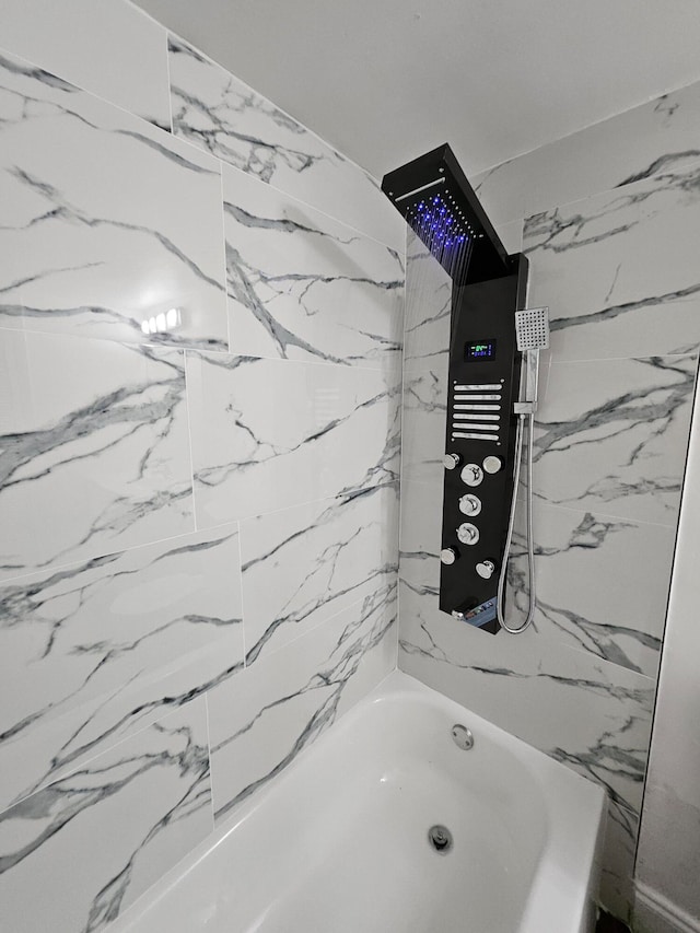 bathroom featuring tiled shower / bath