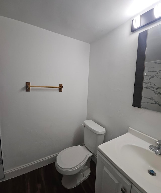 bathroom featuring hardwood / wood-style floors, vanity, and toilet