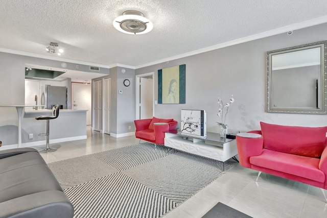 tiled living room with a textured ceiling and crown molding