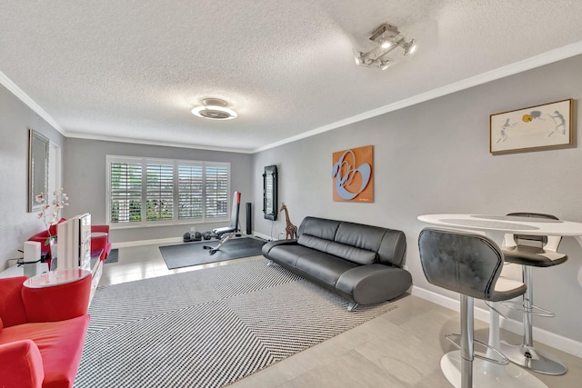 living room featuring ornamental molding and a textured ceiling