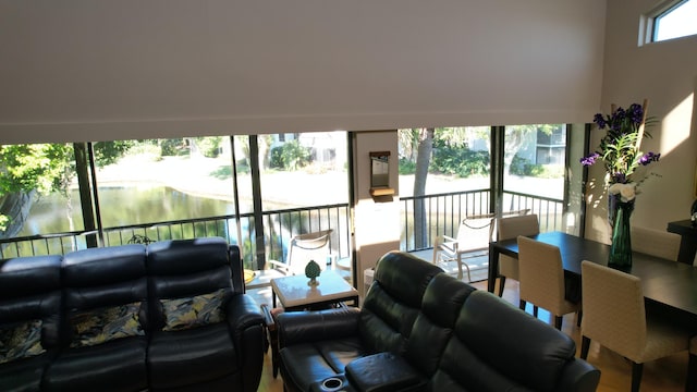 living room with wood-type flooring and a high ceiling