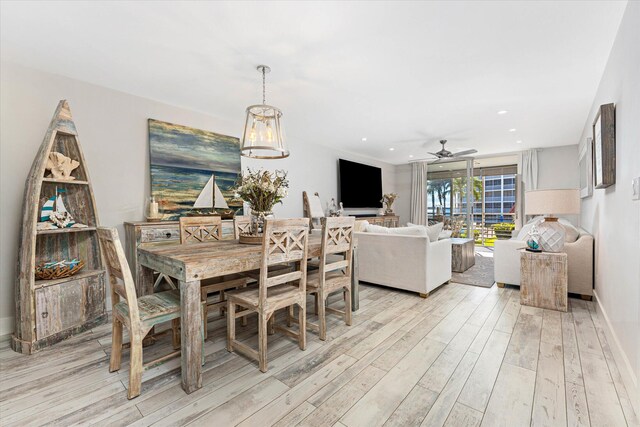 dining area with light hardwood / wood-style flooring and ceiling fan