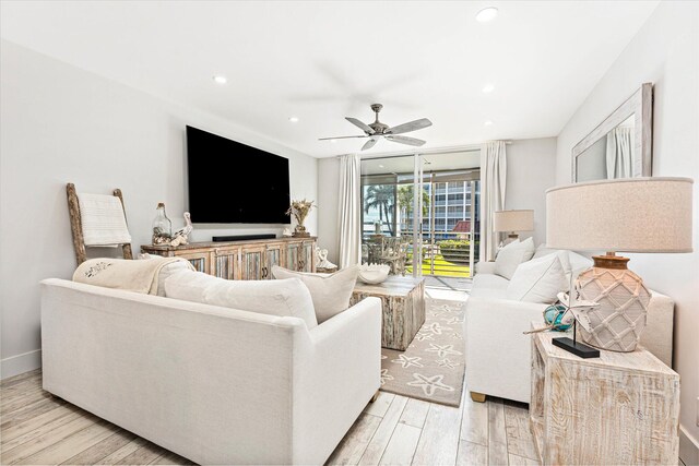 living room featuring ceiling fan and light wood-type flooring