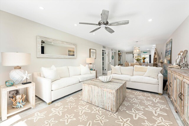 living room with ceiling fan and light hardwood / wood-style floors