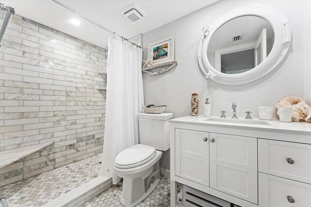 bathroom featuring tile patterned floors, toilet, vanity, and a shower with shower curtain