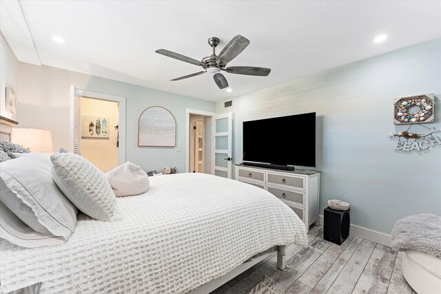 bedroom with ceiling fan and light hardwood / wood-style floors