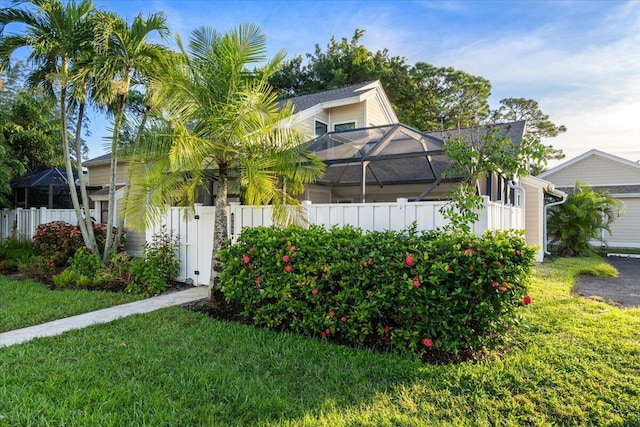 view of front of home with a lanai and a front yard