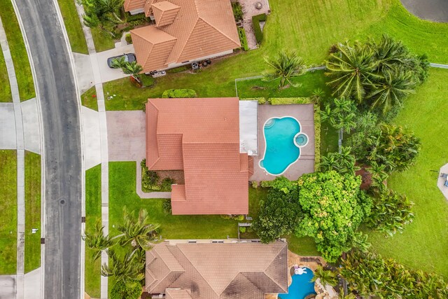 rear view of house featuring a patio area and a swimming pool with hot tub