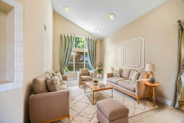 sitting room featuring light tile patterned floors, baseboards, visible vents, and vaulted ceiling