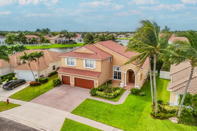 mediterranean / spanish-style house with a front yard and a garage