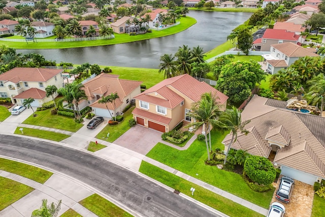 drone / aerial view featuring a water view and a residential view