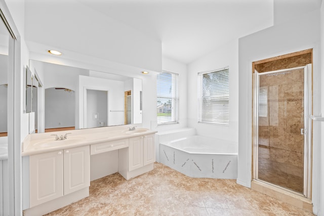 full bath with a bath, a shower stall, double vanity, and a sink