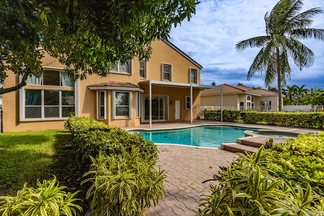 view of pool featuring a fenced in pool, fence, a patio, and an in ground hot tub