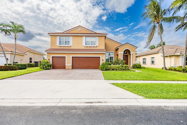 view of front of property featuring a garage, a tile roof, decorative driveway, stucco siding, and a front lawn