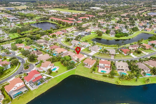 drone / aerial view with a water view and a residential view