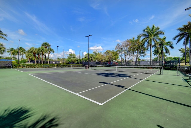 view of tennis court featuring fence