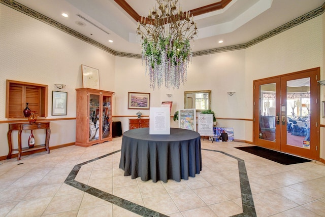 foyer entrance featuring a tray ceiling, french doors, baseboards, and recessed lighting