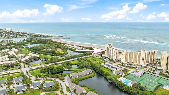 drone / aerial view featuring a water view and a view of the beach