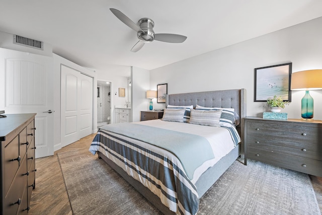 bedroom featuring connected bathroom, ceiling fan, and dark wood-type flooring