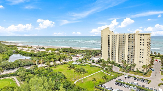 birds eye view of property with a beach view and a water view