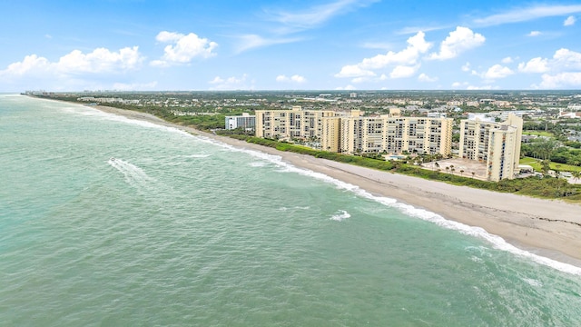 birds eye view of property featuring a water view and a beach view