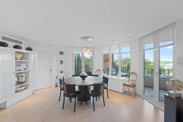 dining area with light hardwood / wood-style floors and french doors