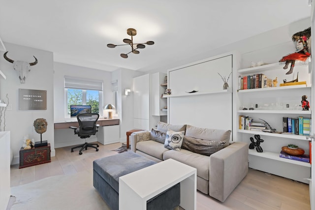 living room featuring light hardwood / wood-style flooring and an inviting chandelier