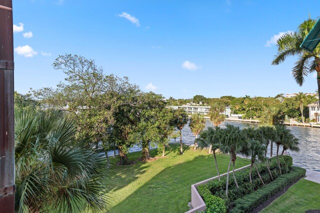 surrounding community featuring a lawn and a water view