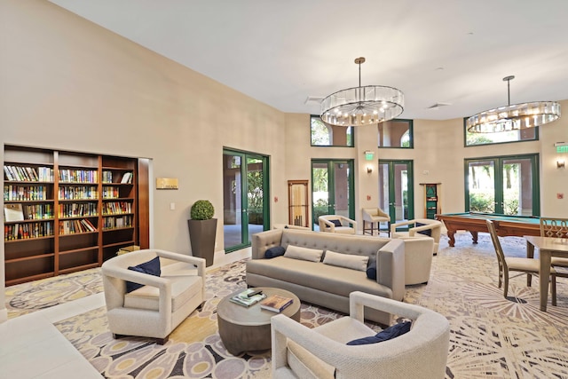 living room featuring french doors, a towering ceiling, a chandelier, light tile patterned flooring, and pool table