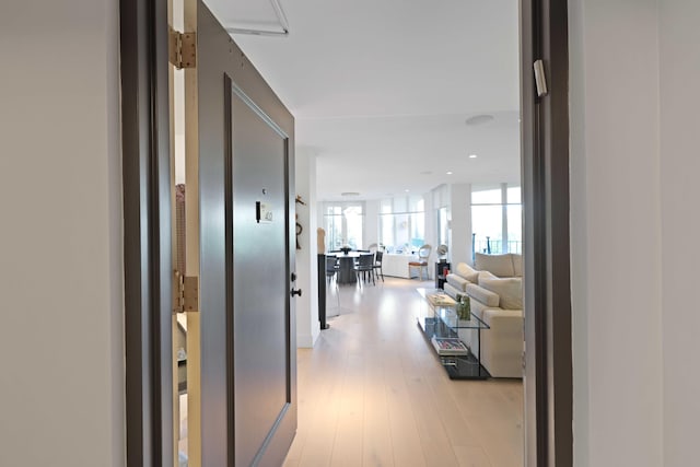 hallway with light hardwood / wood-style flooring