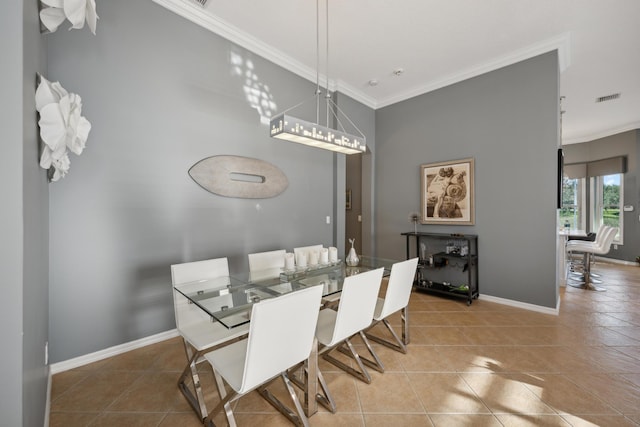 dining room with tile patterned floors and crown molding