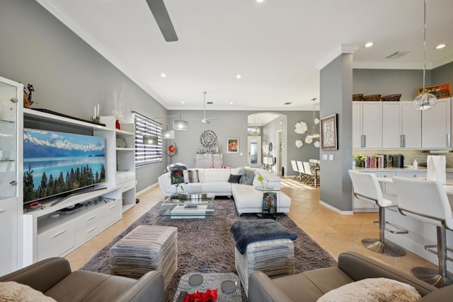 tiled living room with ceiling fan and ornamental molding