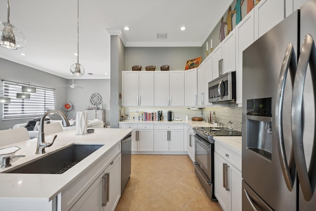 kitchen with white cabinets, pendant lighting, appliances with stainless steel finishes, and sink