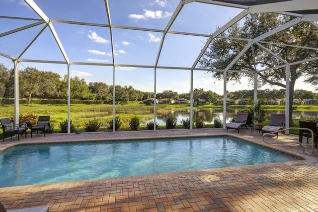 view of swimming pool with a patio area, a lanai, and a water view