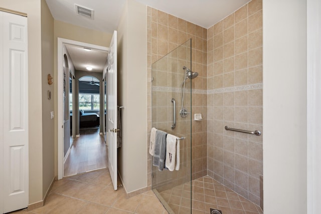 bathroom featuring an enclosed shower and tile patterned flooring