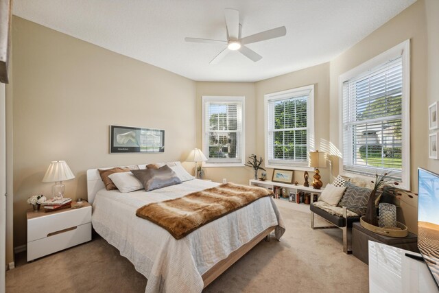 carpeted bedroom featuring ceiling fan