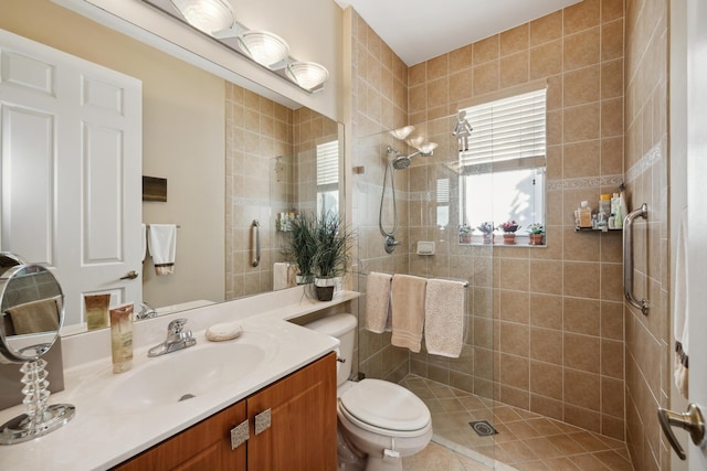 bathroom featuring a shower with shower door, vanity, and toilet