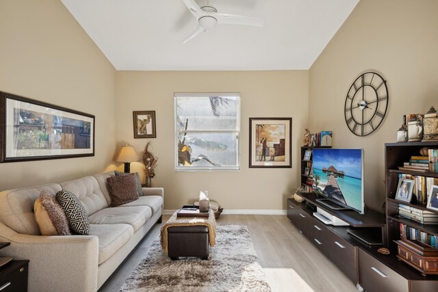 living room featuring ceiling fan and light hardwood / wood-style floors