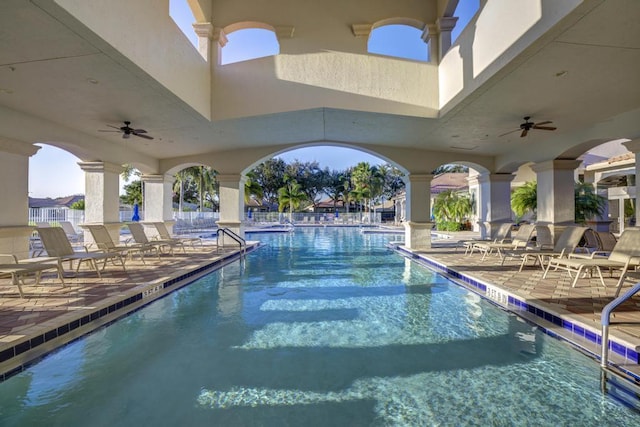 view of pool with ceiling fan and a patio