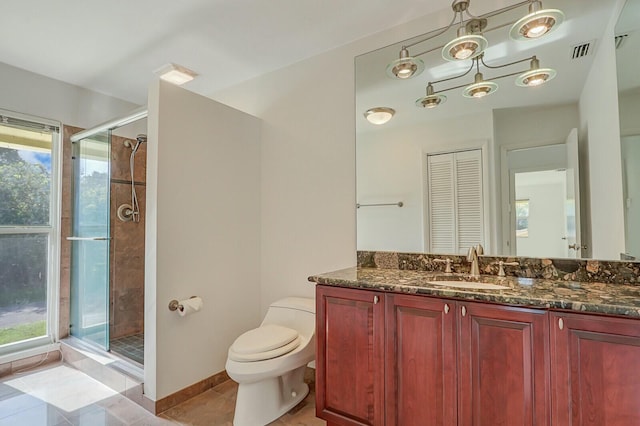 bathroom with tile patterned flooring, plenty of natural light, toilet, and vanity