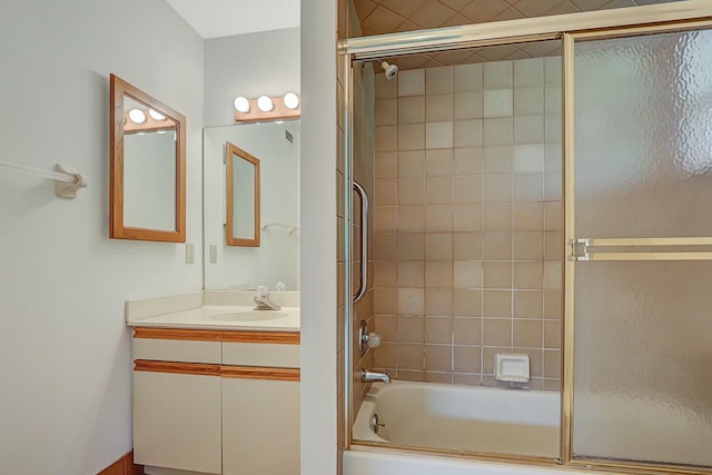 bathroom with shower / bath combination with glass door and vanity